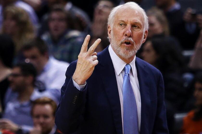 San Antonio Spurs Coach Gregg Popovich gestures from the bench during a game against the Toronto Raptors.