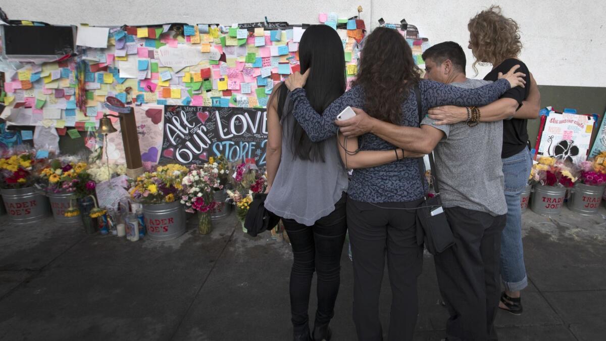MaryLinda Moss, second from left, and three fellow hostages at the memorial outside Trader Joe's.