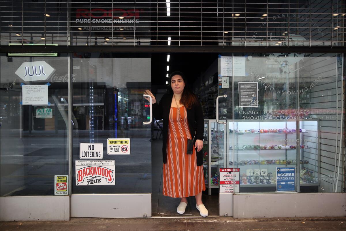 Natali Mishali, 30, stands outside her closed DTLA Smoke Shop in Los Angeles. It has since reopened, after she spent more than $20,000 in legal fees.
