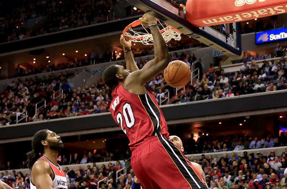 Heat center Greg Oden dunks against the Wizards during his first NBA game in more than four years on Thursday in Washington.