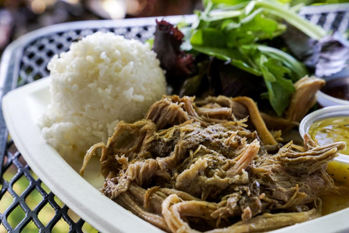 The Pork Plate Lunch, featuring 12-hour slow-roasted Kalua pulled pork, white rice, mesclun salad, homemade guava bbq sauce, and homemade papaya seed dressing at Kono's at the North Shore Marketplace.
