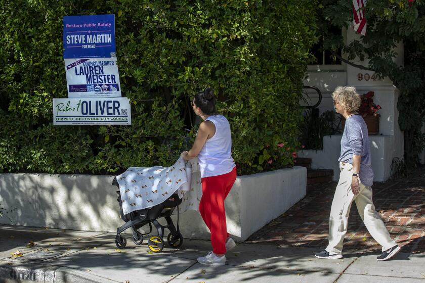 WEST HOLLYWOOD, CA-OCTOBER 26, 2022: Signs with the name of a candidate for the West Hollywood City Council are placed in front of a home on Elevado Ave. in West Hollywood. The contentious election for three seats on the West Hollywood City Council has become a contest between traditional liberals and so-called "woke" people who pushed to cut the number of sheriff's deputies. (Mel Melcon / Los Angeles Times)