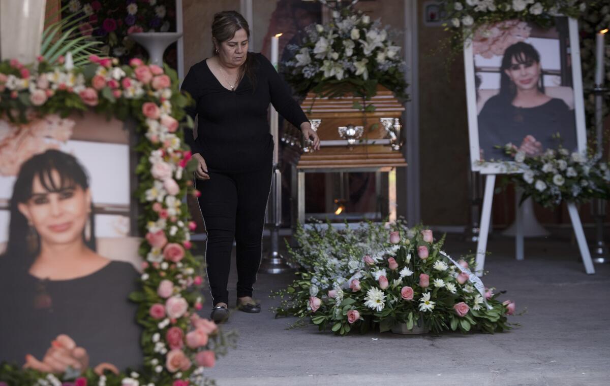 Pictures of Rosa Alma Barragán surround her casket 