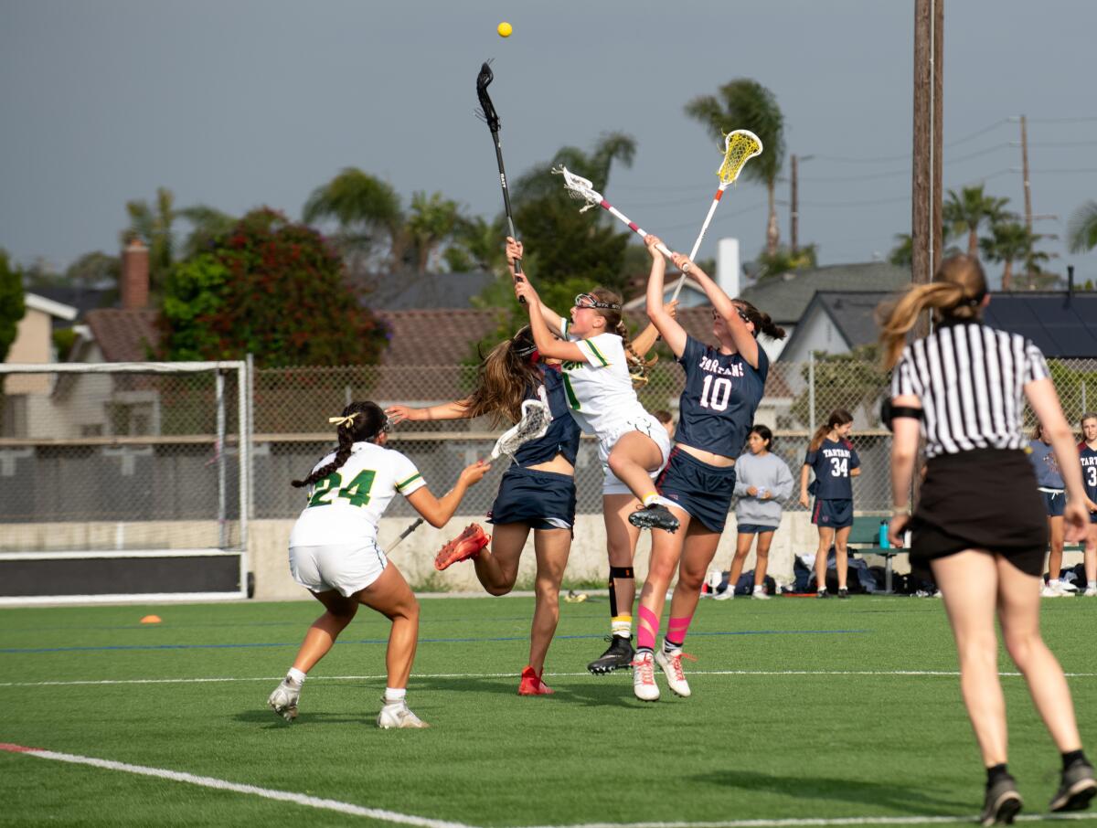The Edison and St. Margaret's girls' lacrosse teams battle for possession during Thursday's match. 