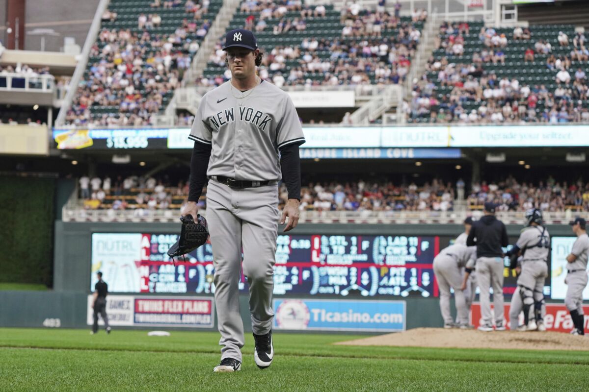 New York Yankees pitcher Gerrit Cole heads to the dugout after he was pulled during the third inning of the team's baseball game against the Minnesota Twins, Thursday, June 9, 2022, in Minneapolis. Cole gave up five home runs in 2 1/3 innings. (AP Photo/Jim Mone)