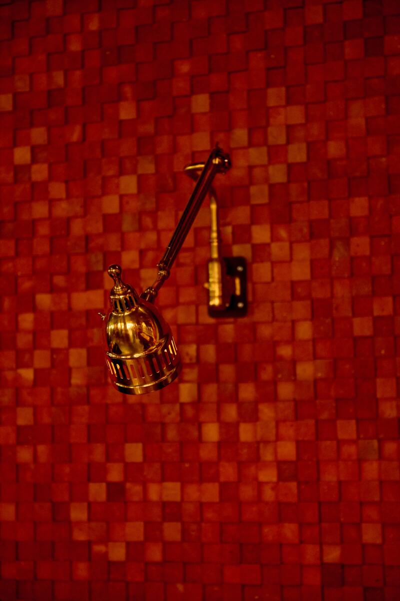 A lamp against the red brick interior of Star Leaf.