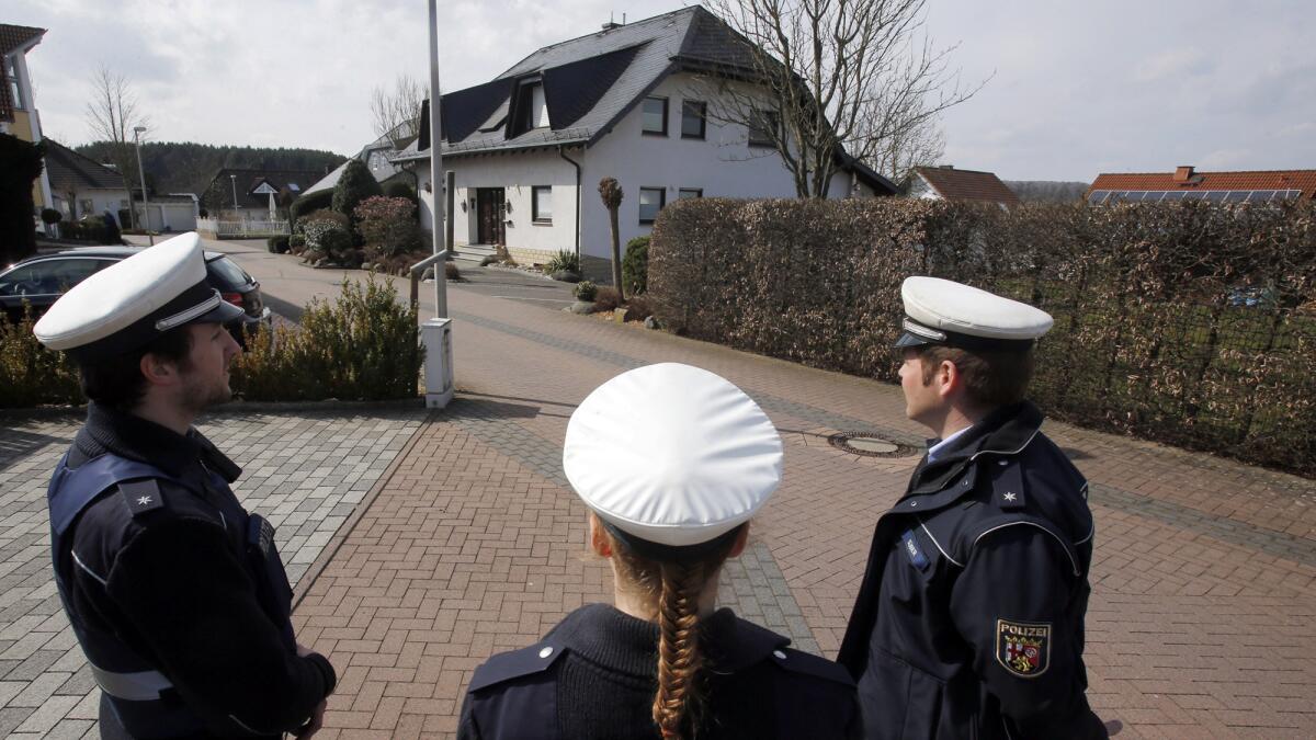 Police stand outside the house in Montabaur, Germany, where Andreas Lubitz, the co-pilot believed to have deliberately crashed a Germanwings jet, lived.