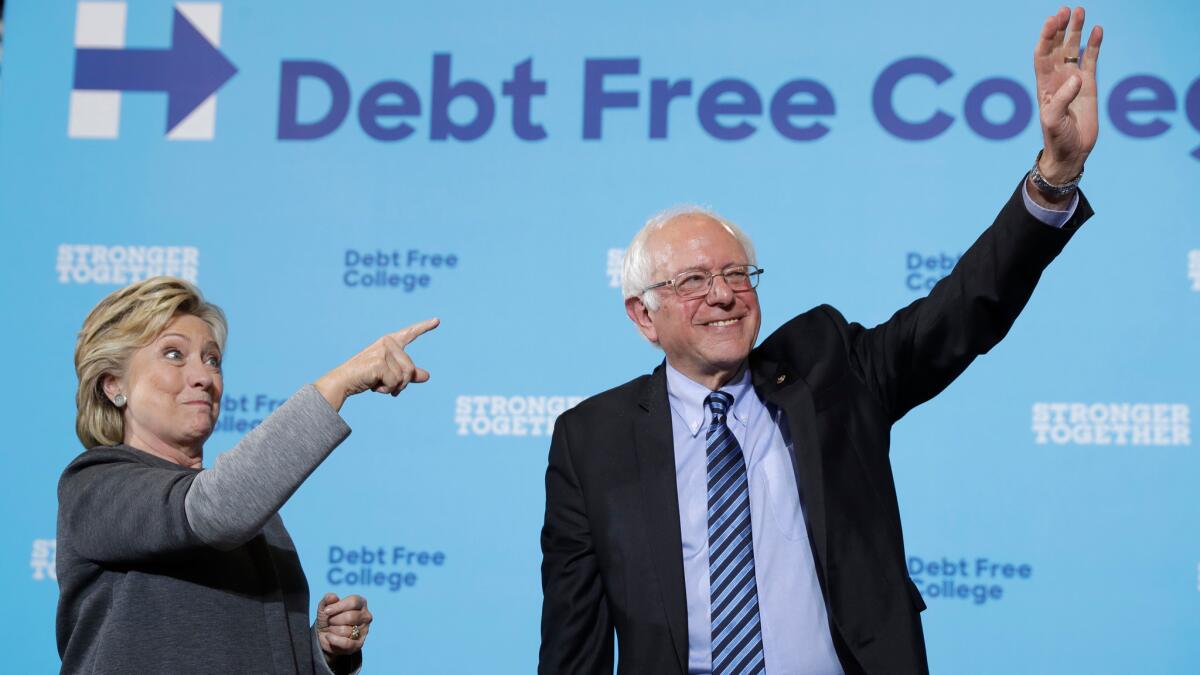 Hillary Clinton and Vermont Sen. Bernie Sanders campaign in Durham, N.H., on Wednesday.