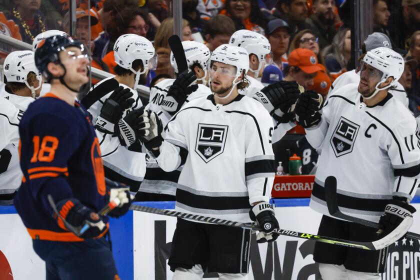 Los Angeles Kings Adrian Kempe, center, celebrates his goal with teammates as Edmonton Oilers left wing Zach Hyman looks away during the second period of Game 5 of an NHL hockey Stanley Cup first-round playoff series, Tuesday, May 10, 2022 in Edmonton, Alberta. (Jeff McIntosh/The Canadian Press via AP)