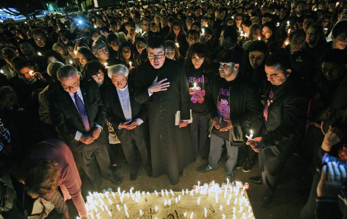 The Genocide Memorial is blessed at a candlelight vigil after a ceremony sponsored by United Young Armenians in the parking lot of the Glendale Civic Auditorium on Thursday, April 23, 2015.