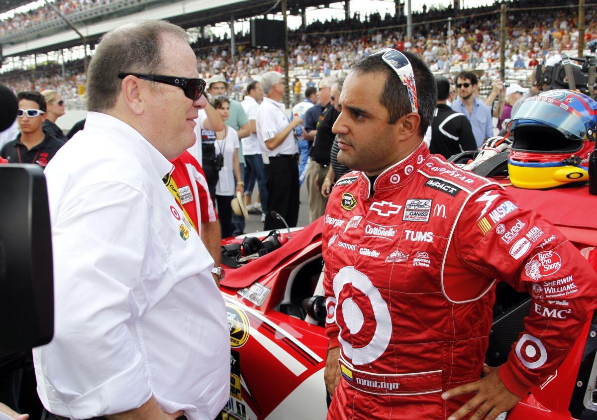 NASCAR Sprint Cup driver Juan Pablo Montoya, right, speaks with team owner Chip Ganassi before the start of the 2010 Brickyard 400 at Indianapolis Motor Speedway.