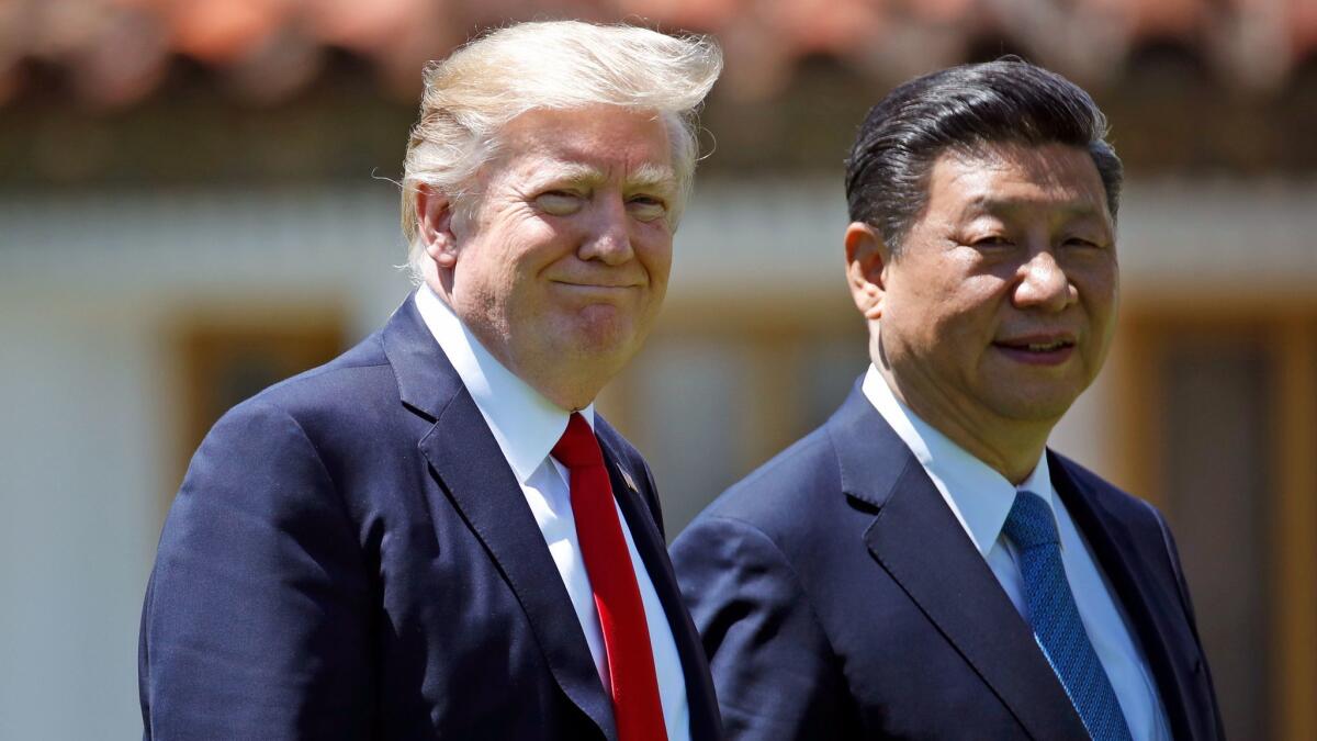 President Donald Trump and Chinese President Xi Jinping walk together after their meetings at Mar-a-Lago in Palm Beach, Fla. on April 7.