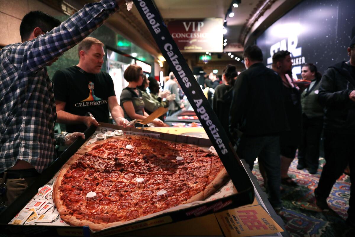 Director J.J. Abrams sent over giant pizzas to feed fans during a “Star Wars” marathon at the El Capitan Theatre.