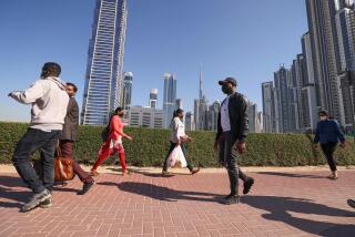 Employees walk to work on the first working Friday in the Gulf Emirate of Dubai, on January 7, 2022. - The United Arab Emirates has changed its workweek, making Sunday which is a work day in much of the Muslim world, part of the weekend. (Photo by Karim SAHIB / AFP) (Photo by KARIM SAHIB/AFP via Getty Images)