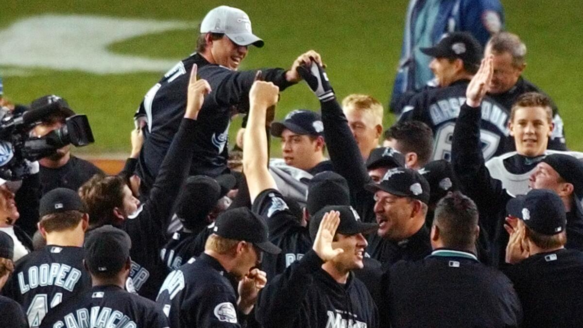 Florida Marlins pitcher Josh Beckett is carried off the field by his teammates after the team's World Series win over the New York Yankees in 2003. Beckett isn't the only current Dodgers player to record the final out of a World Series.