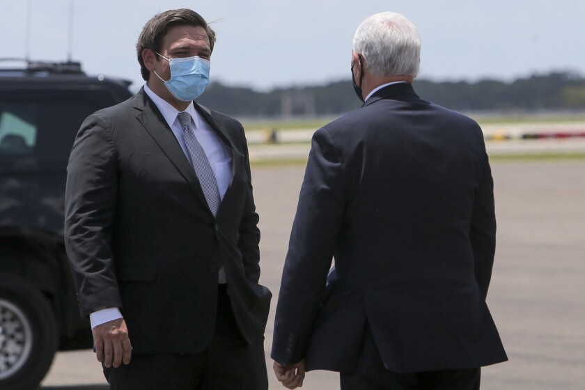 Florida Gov. Ron DeSantis greets Vice President Mike Pence upon his arrival at Tampa International Airport on Thursday. 