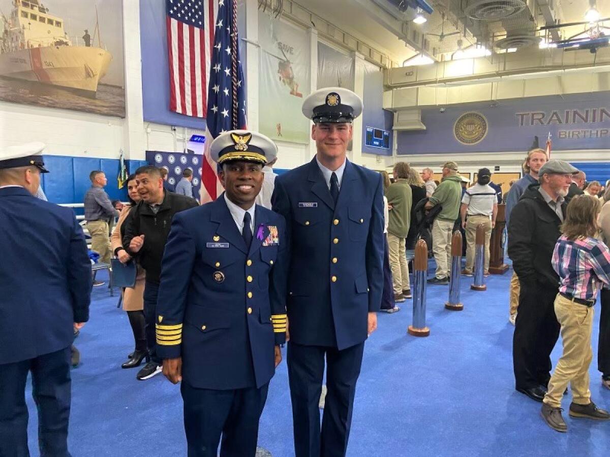 Former OCC student Jake Buscaglio, right, with Capt. Warren D. Judge, Commanding Officer of Coast Guard's Training Center.