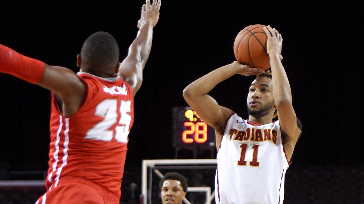 USC guard Jordan McLaughlin, shooting over New Mexico guard Tim Jacobs during a game Nov. 21, averages 12. 4 points, 5.2 assists and 1.7 steals a game.