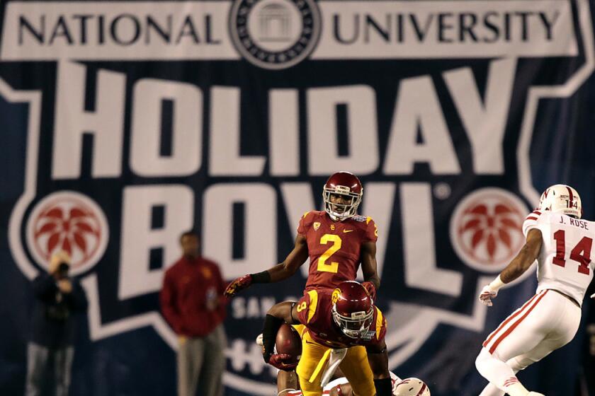 USC receiver Juju Smith can't escape the tackle of Nebraska during the second half action of the Holiday Bowl at Qualcomm Stadium on Dec. 27, 2014.