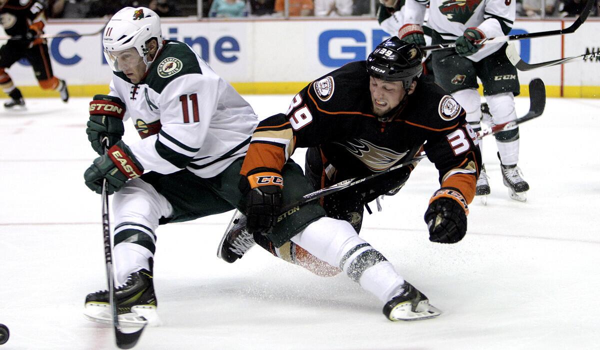 Ducks left wing Matt Beleskey (39) can't prevent Wild center Zach Parise (11) from clearing the puck during the second period Friday night at Honda Center.