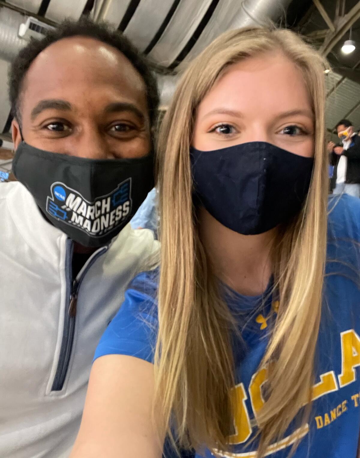 UCLA athletic director Martin Jarmond and dance team member Alicia Beebe pose for a selfie