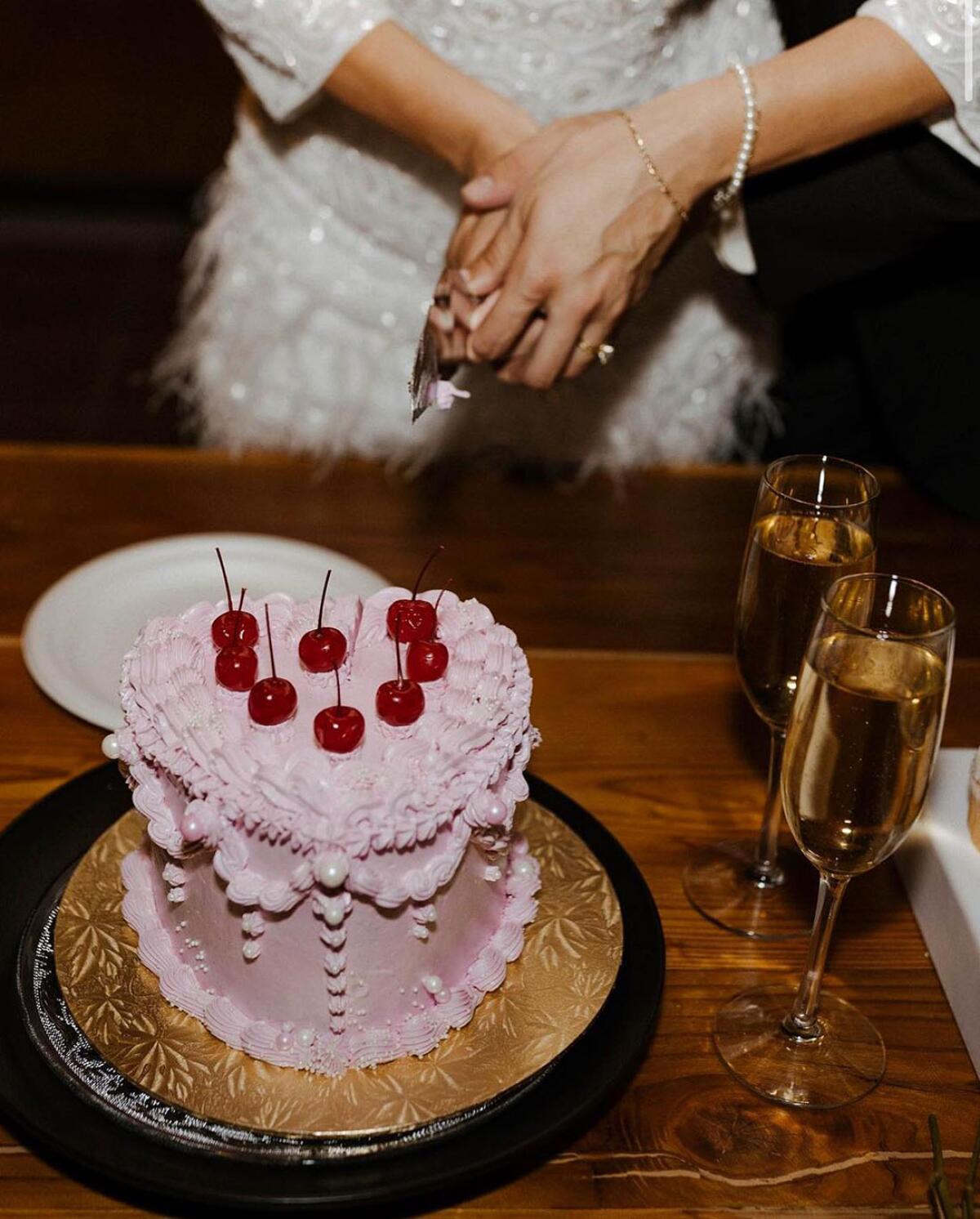 A heart cake with cherries.