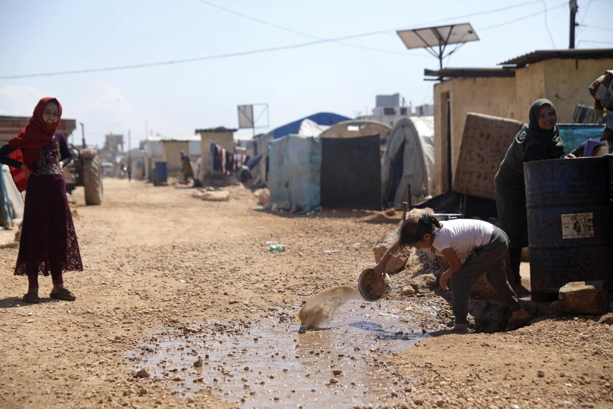 Refugees are shown at a large camp on the Syrian side of the border with Turkey in April.