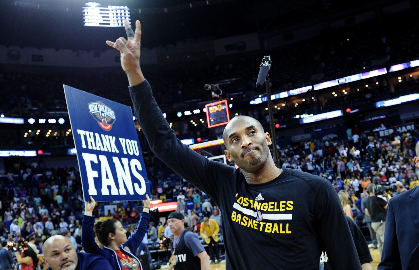 Kobe Bryant waves goodbye to fans as the Lakers leave the court following their loss to the Pelicans in the future Hall-of-Famers final game in New Orleans.