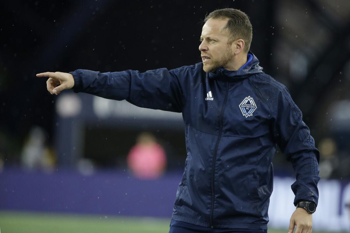Vancouver Whitecaps coach Marc dos Santos instructs his players during a 2019 match against the New England Revolution.