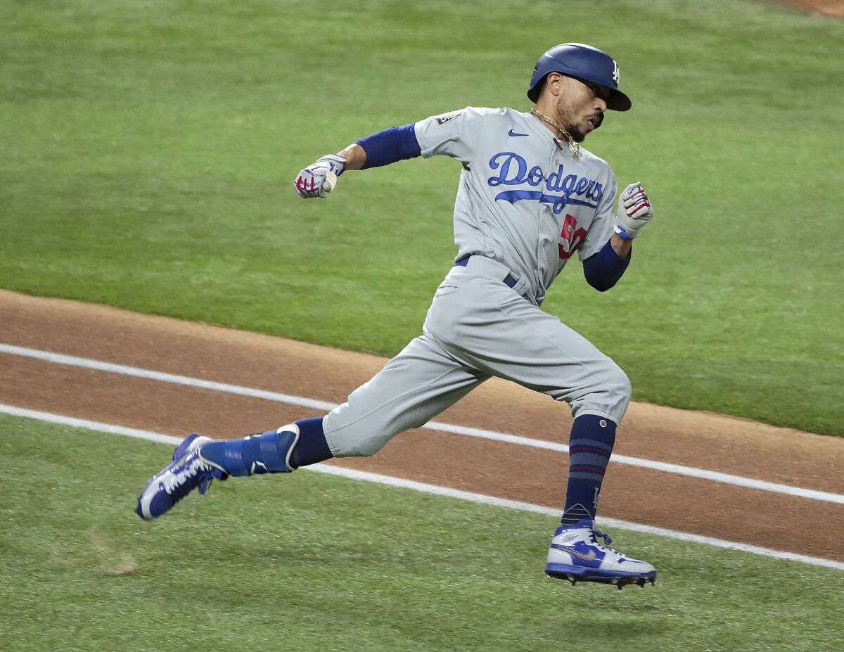 Dodgers right fielder Mookie Betts hustles to second base for a double in Game 5 of the World Series.