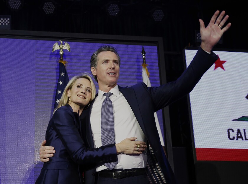 Gavin Newsom celebrates his election as California governor with his wife, Jennifer Siebel Newsom, on election night in November 2018.