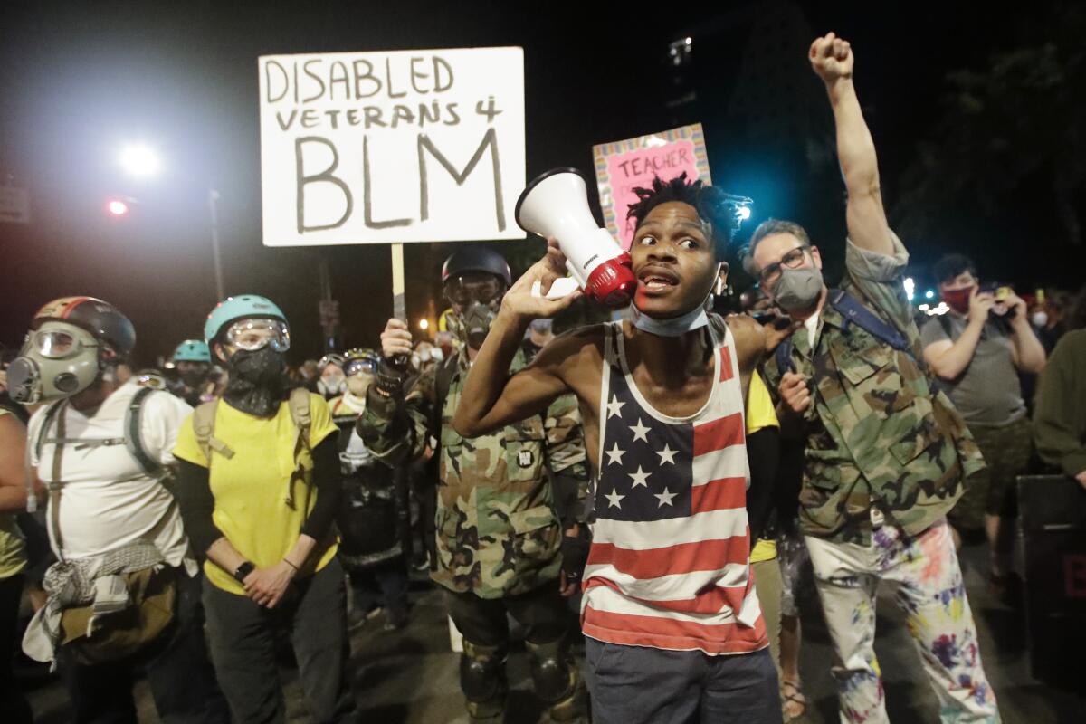 Demonstrators participate in a Black Lives Matter protest in Portland, Ore., on July 26. 