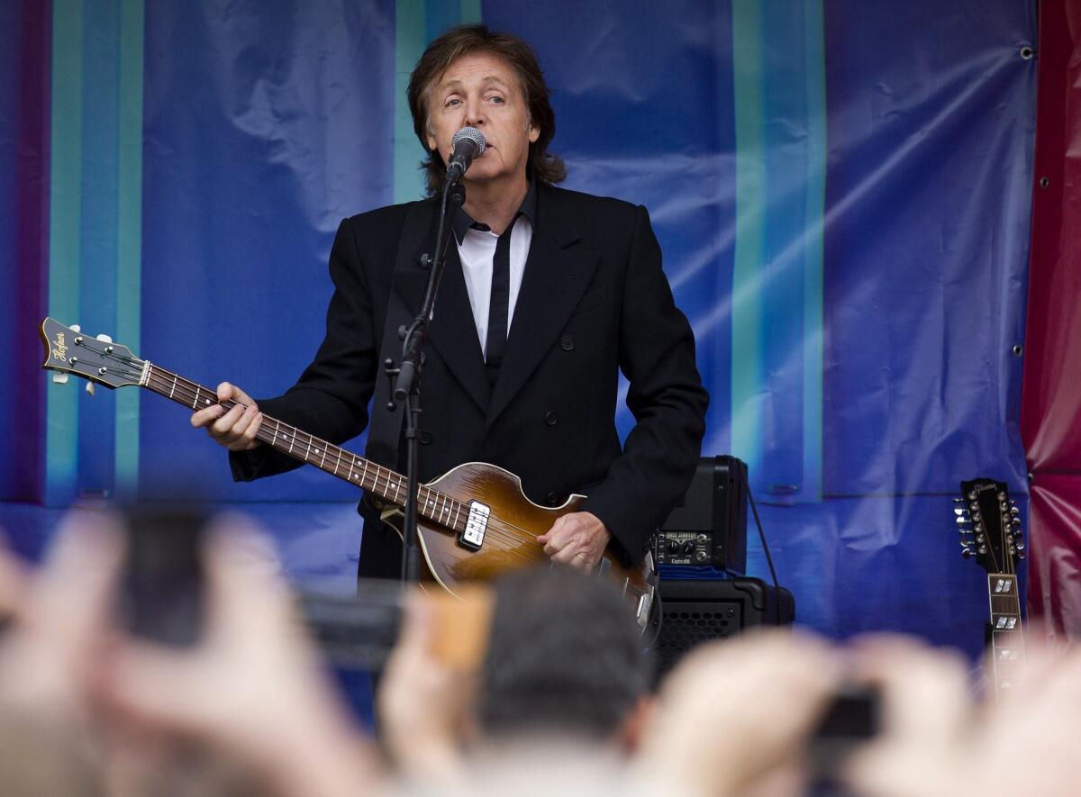 Paul McCartney performs during an impromptu gig in Covent Garden in London. The former Beatle and his band performed half a dozen songs from the back of a truck.