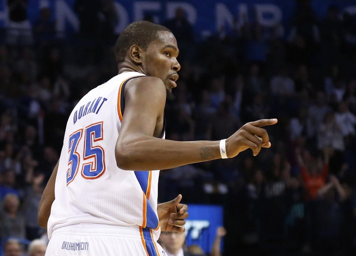 Thunder forward Kevin Durant acknowledges the efforts of a teammate after making a basket in the fourth quarter against the Memphis Grizzlies in Oklahoma City.