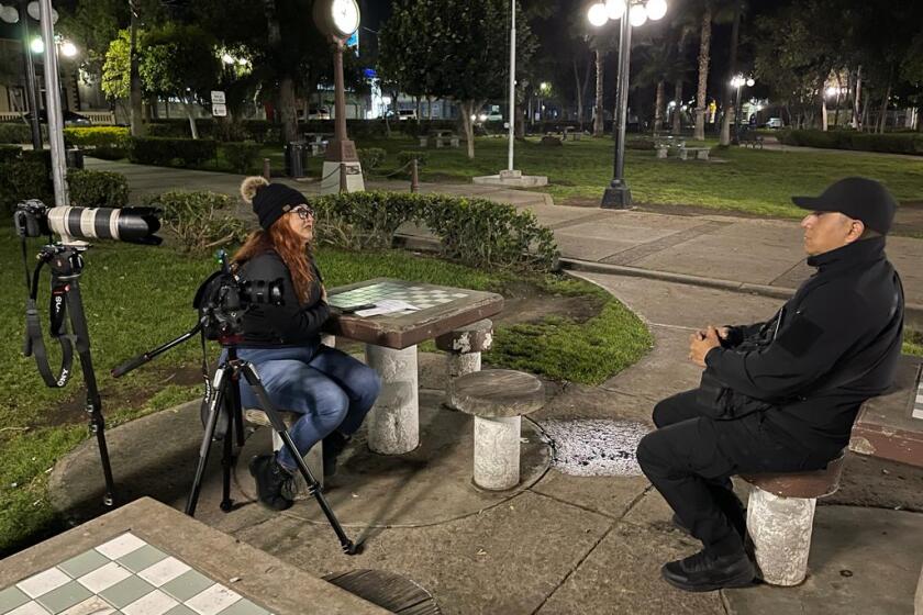 The San Diego Union-Tribune reporter Tania Navarro interviews photojournalist Arturo Rosales while filming the documentary series "Journalism at Risk" in Tijuana's Teniente Guerrero Park on March 29, 2022.