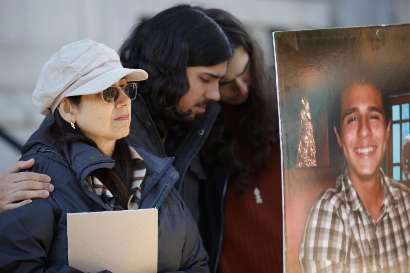 FILE - Belkis Terán, left, Daniel Paez, center, and Pedro Terán, family members of Manuel Esteban Paez Terán, right, embrace during a news conference, Monday, March 13, 2023, in Decatur, Ga. Georgia authorities allege that in January 2023, state troopers fatally shot an environmental protester who had fired at authorities after a trooper shot pepper balls into the protester’s tent, according to incident reports obtained Friday, March 23, by the Atlanta Journal-Constitution. Paez Terán was killed in DeKalb County's South River Forest as officers tried to clear activists who were camping near the site of a planned police and training center that protesters call “Cop City.” (AP Photo/Alex Slitz, File)