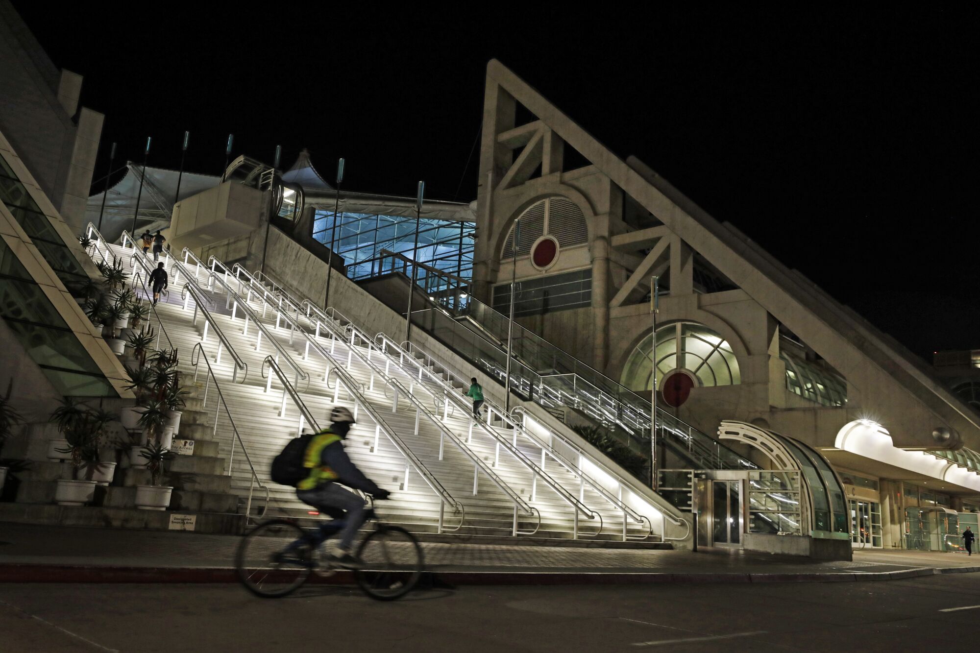 People exercise on the steps at the San Diego Convention Center. 