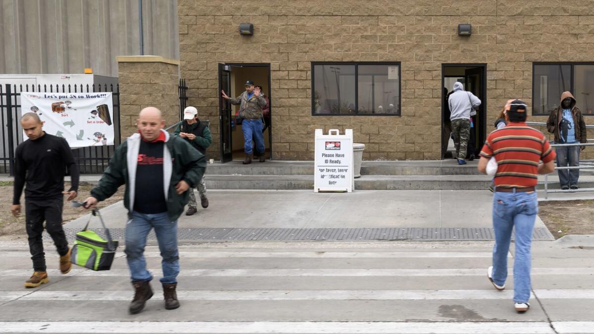 JBS plant employees during the shift change in Grand Island, Neb.