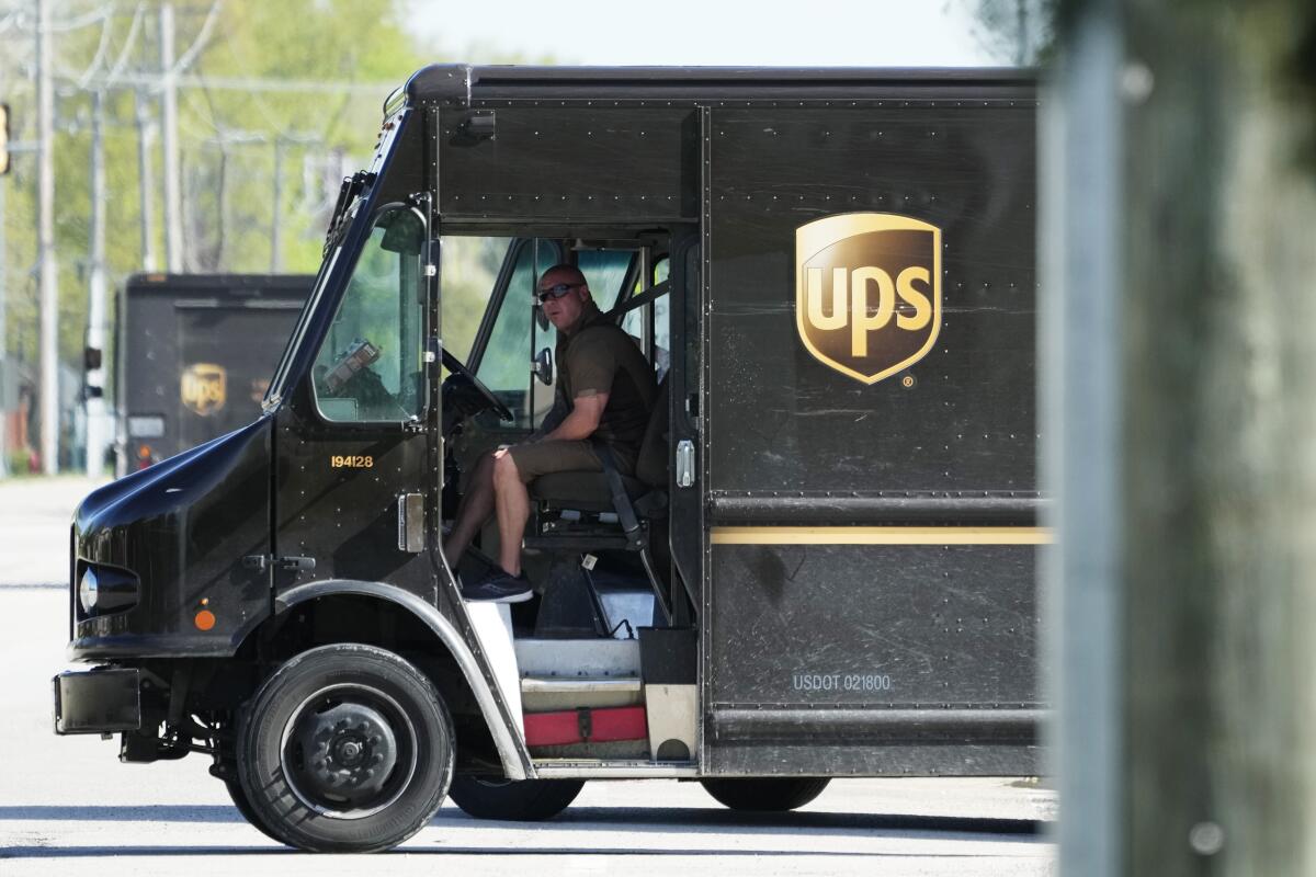 A United Parcel Service driver is inside a delivery vehicle.