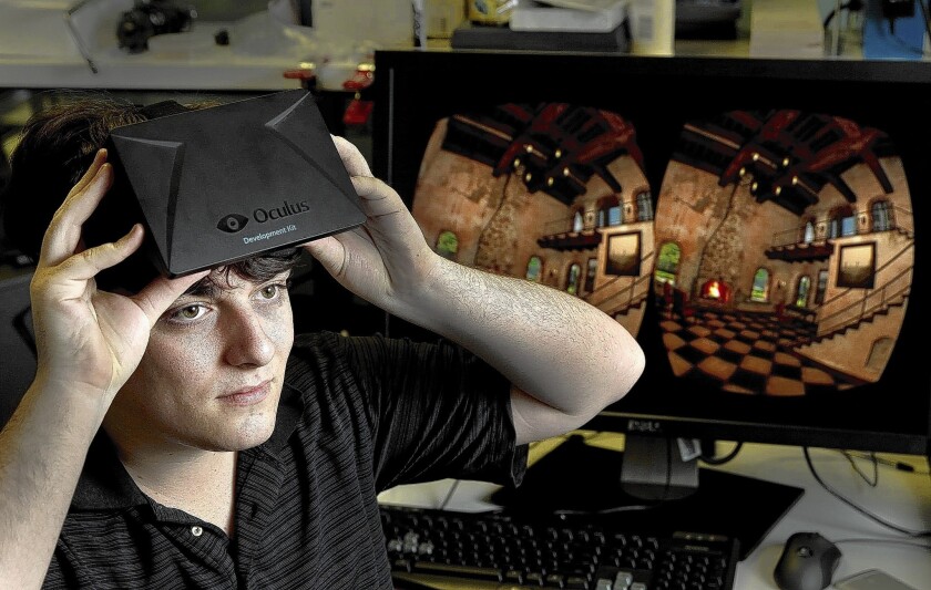 Palmer Luckey, founder of Oculus, holds a Rift headset in his Irvine offices last year.