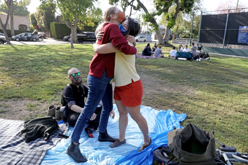 Jessica Holzer, 35, of West Hollywood, hugs friend Madeline Brozen, 35, of Los Angeles