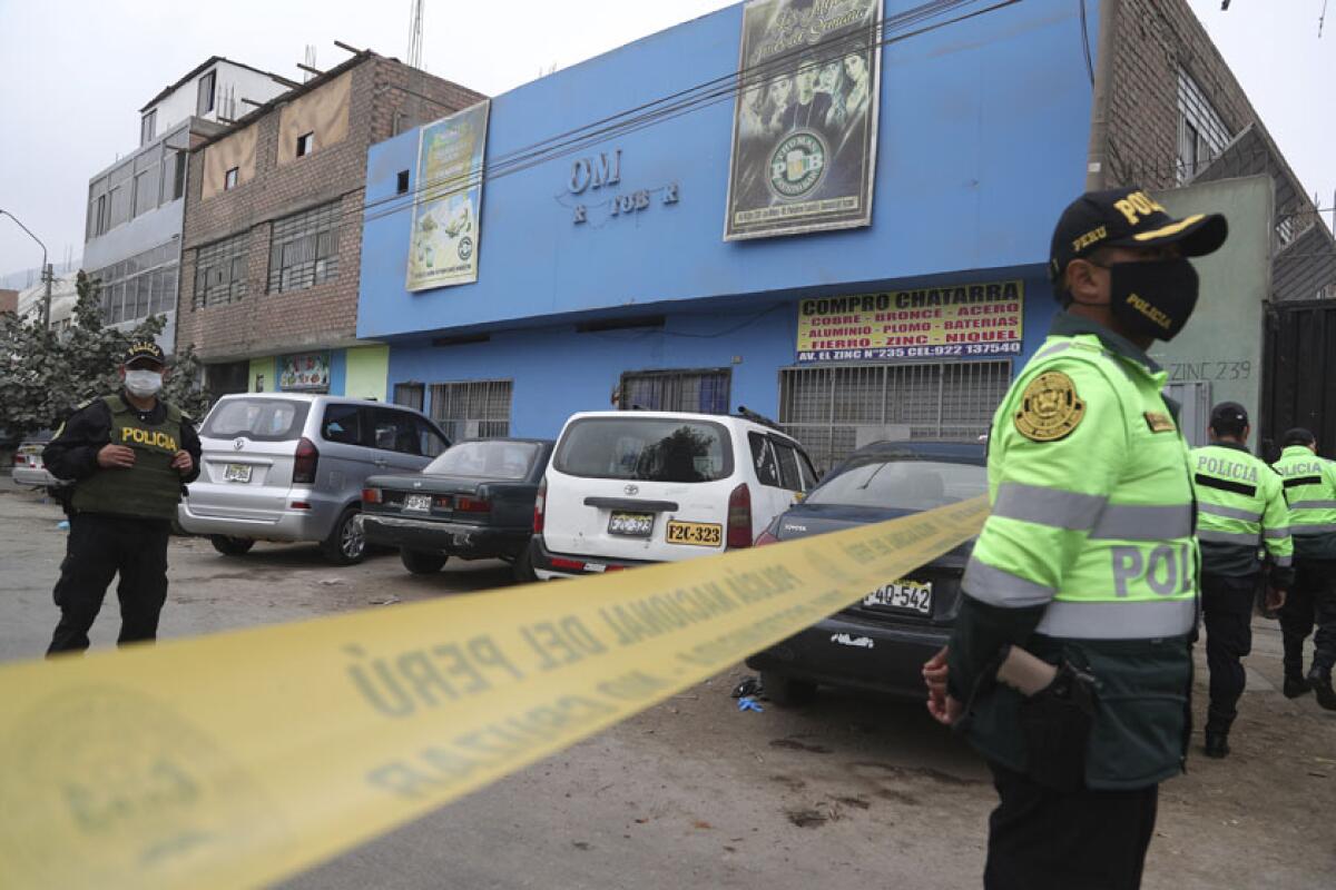 Police officers outside the Thomas disco in Lima, Peru, where officials said 13 died in a stampede.