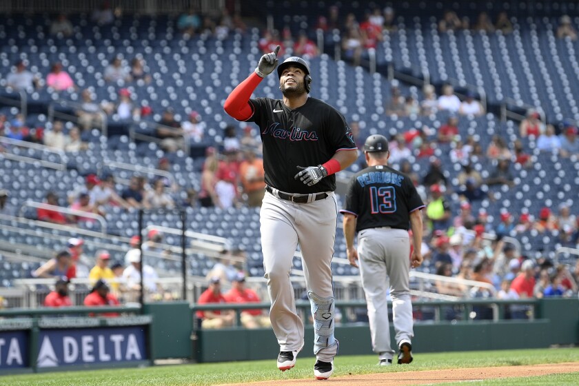 Miami Marlins' Jesus Aguilar celebrates his two-run home run during the first inning of a baseball game against the Washington Nationals, Saturday, July 2, 2022, in Washington. (AP Photo/Nick Wass)
