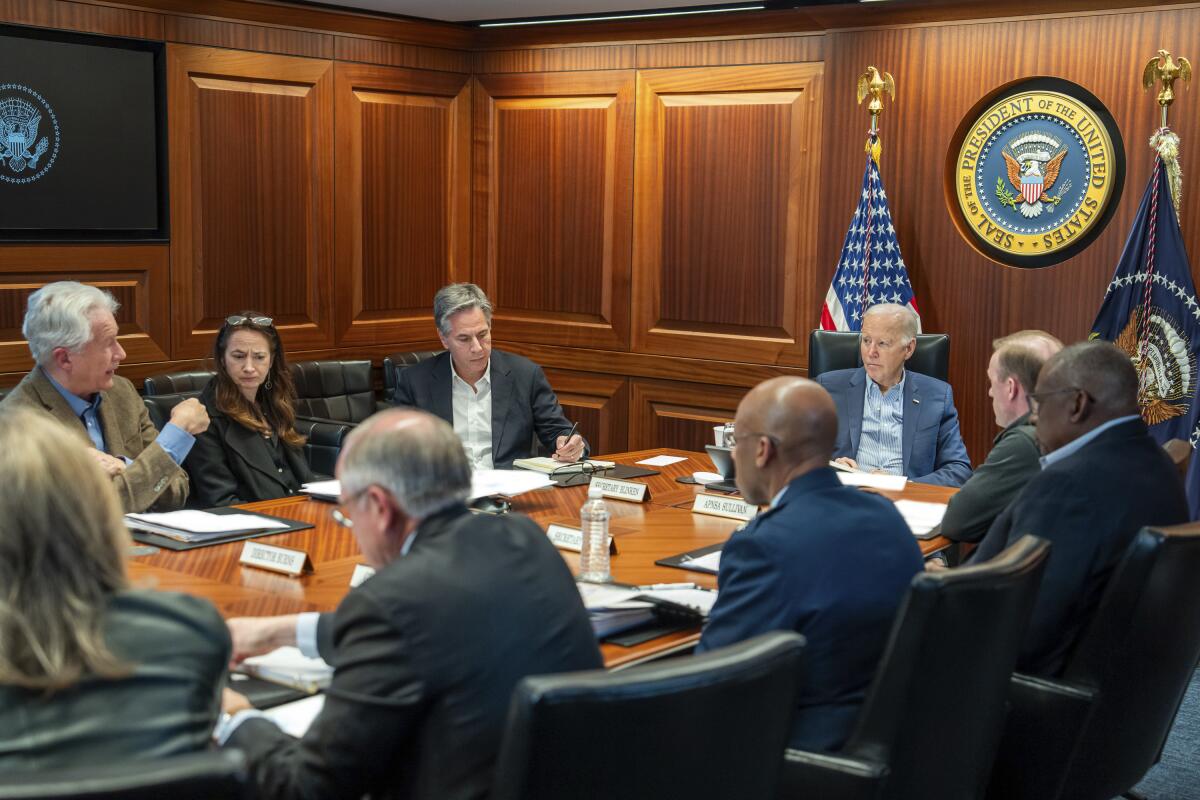 President Biden with other officials in a situation room.