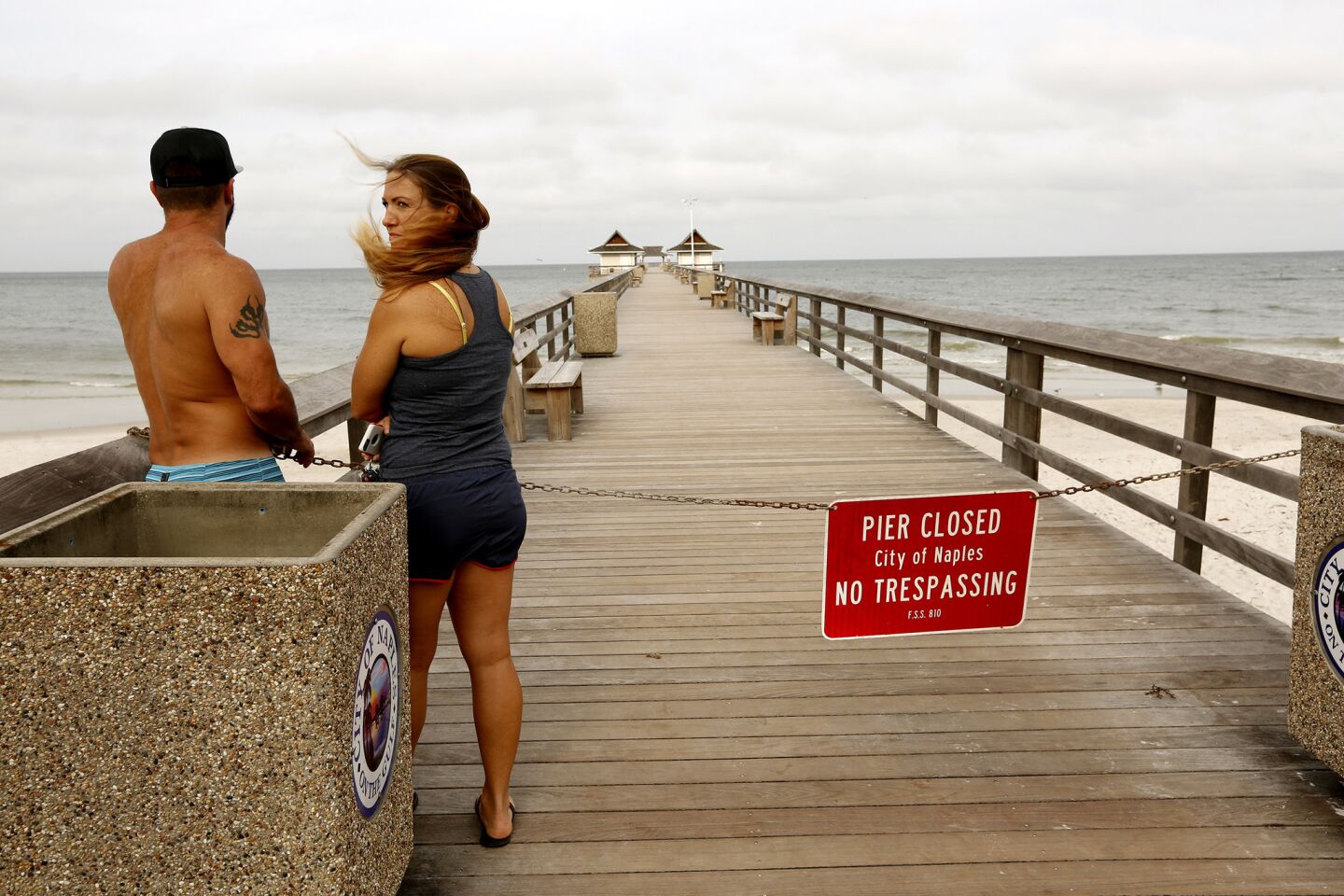 Sherri Bourdo, 32, and Anthony Guidry, 40, look out over the water in Naples, Fla, in advance of the arrival of Hurricane Irma.