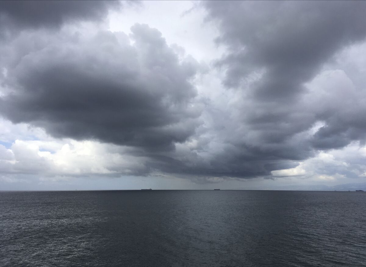 Storm clouds gather over Santa Monica Bay off Manhattan Beach on Sunday.