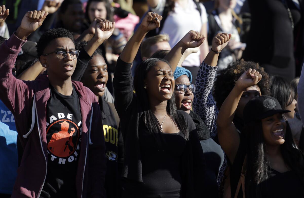 Students cheer while listening to members of the black student protest group Concerned Student 1950 speak in Columbia, Mo., on Monday after the announcement that University of Missouri System President Tim Wolfe would resign.