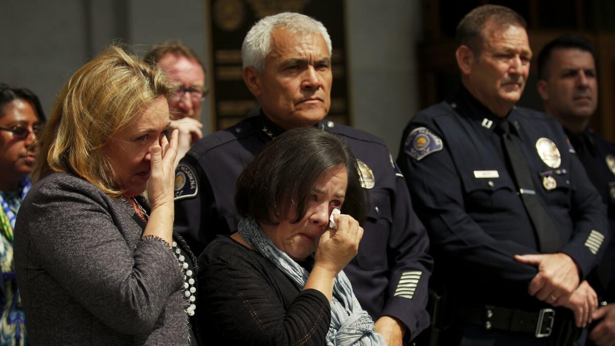 The mother of Aramazd Andressian Jr., Ana Estevez, middle, cries during a news conference in front of the Hall of Justice on May 17.