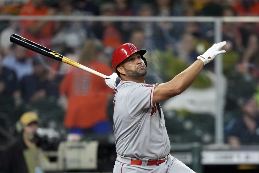 Los Angeles Angels' Albert Pujols watches his home run against the Houston Astros during the sixth inning of a baseball game Thursday, April 22, 2021, in Houston. (AP Photo/David J. Phillip)