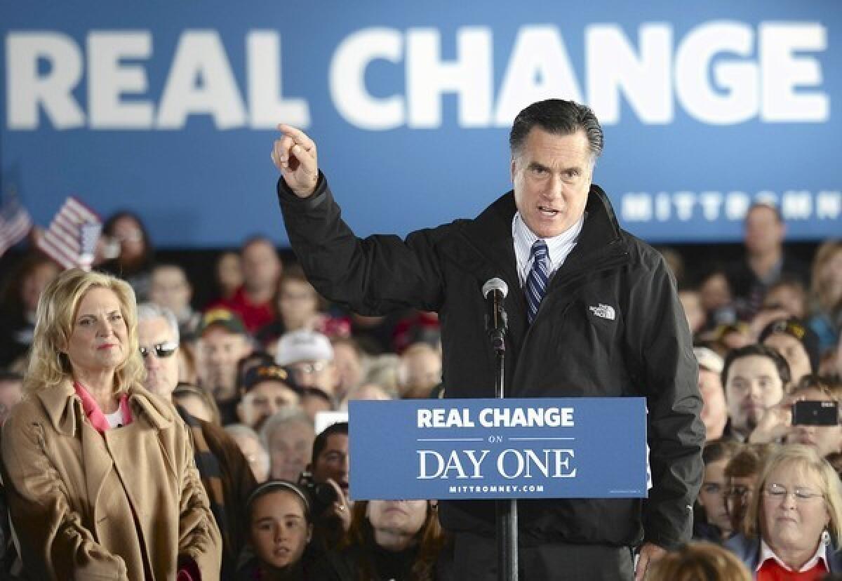 Republican presidential nominee Mitt Romney rallies supporters at the regional airport in Dubuque, Iowa, during a three-state campaign swing on the final weekend before the election.
